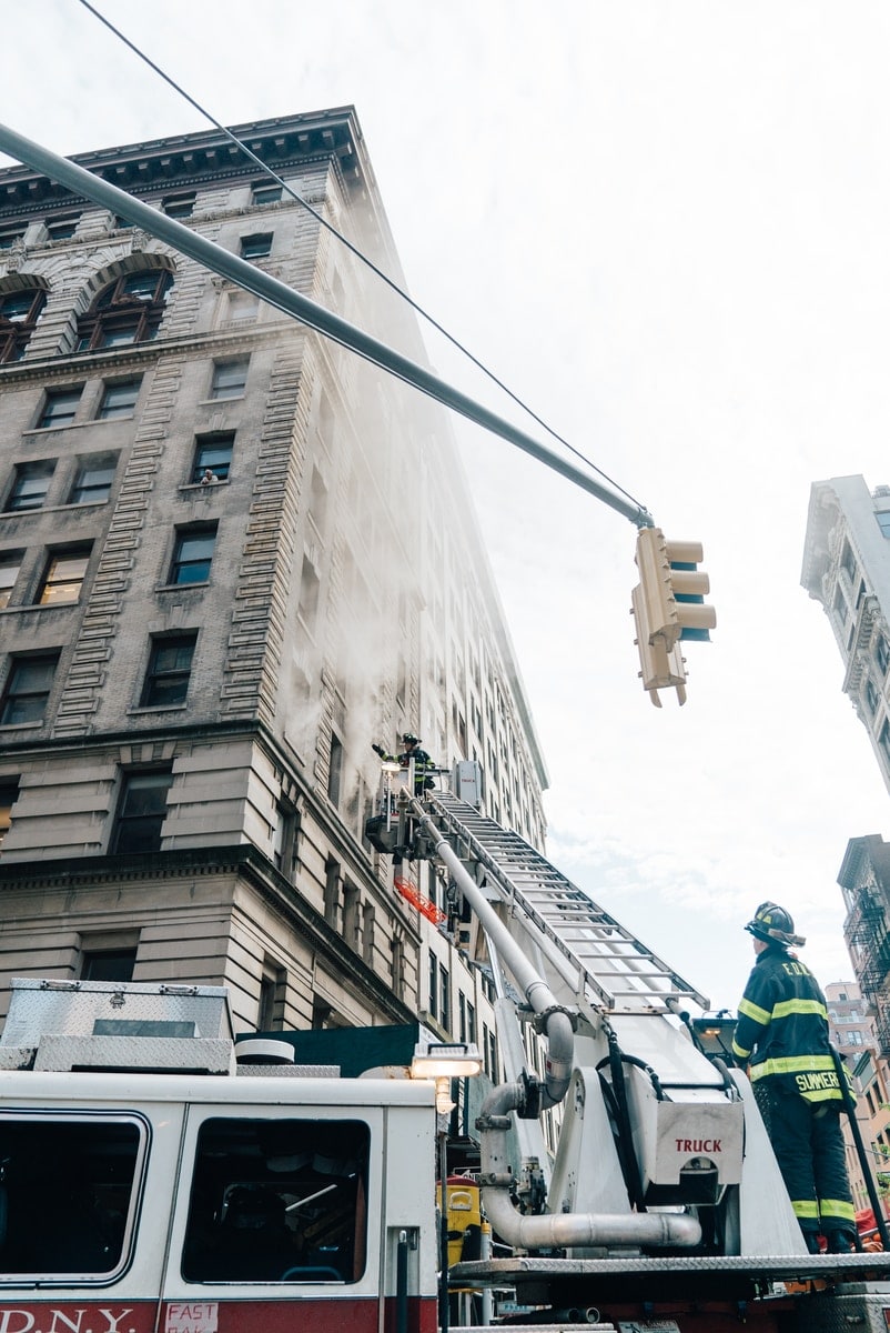 fireman on top of fire ladder